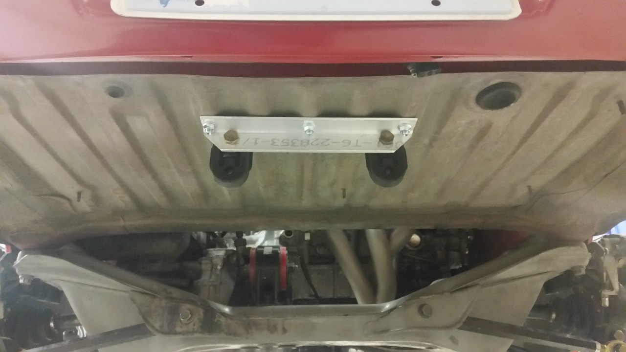 Custom muffler hanger bracket for center exit exhaust