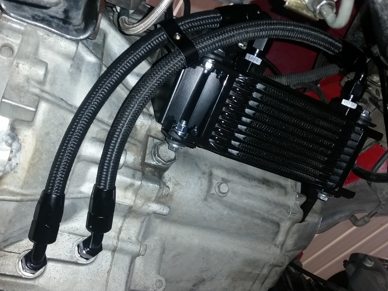 Mounting transmission cooler under car